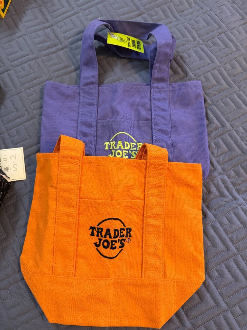 Two Trader Joe's mini tote bags.